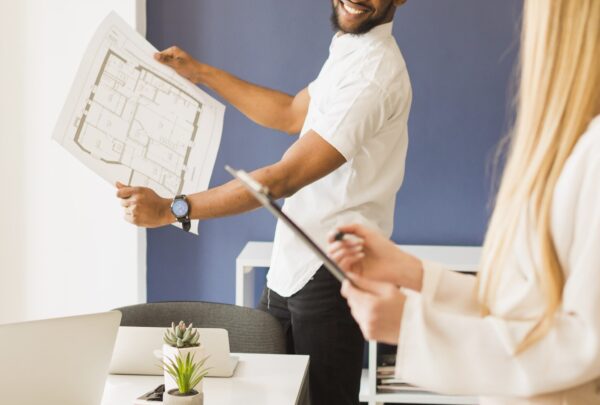 cheerful-man-showing-draft-woman-min cheerful-man-showing-draft-woman-min