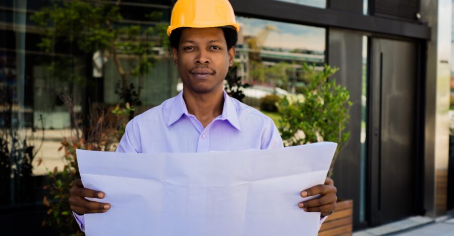 portrait-professional-architect-helmet-looking-blue-prints-outside-modern-building-engineer-architect-concept-min portrait-professional-architect-helmet-looking-blue-prints-outside-modern-building-engineer-architect-concept-min
